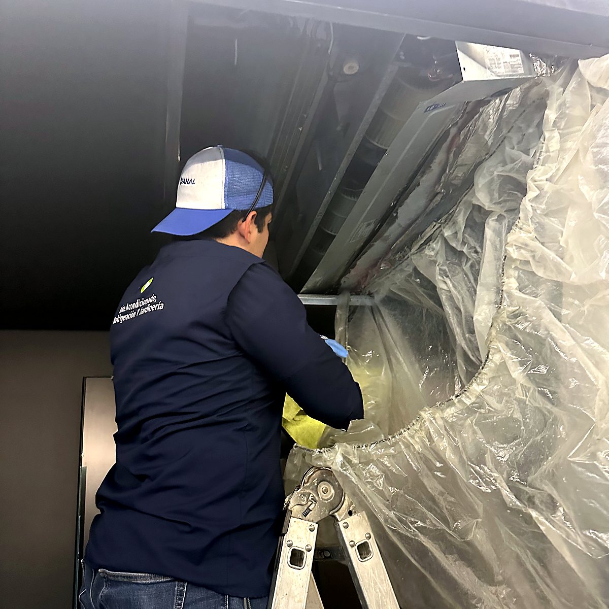 FSG technician cleaning a ceiling unit